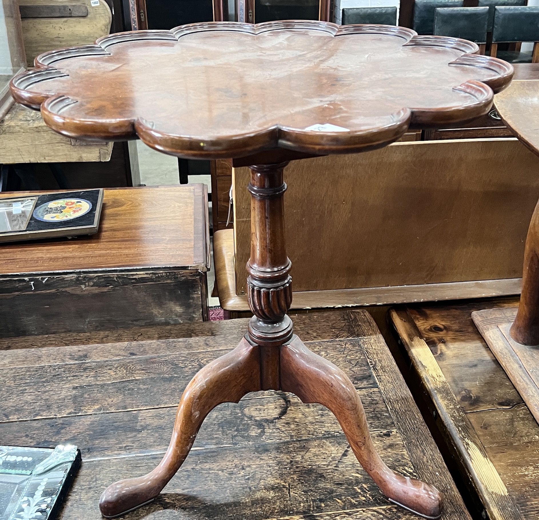 A George III style circular yew tilt top tripod tea table, diameter 65cm, height 68cm